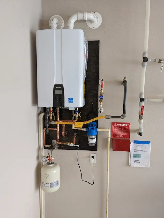 Professional plumber installing copper piping in a North Highlands home